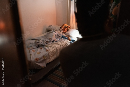Boy wishing goodnight to father