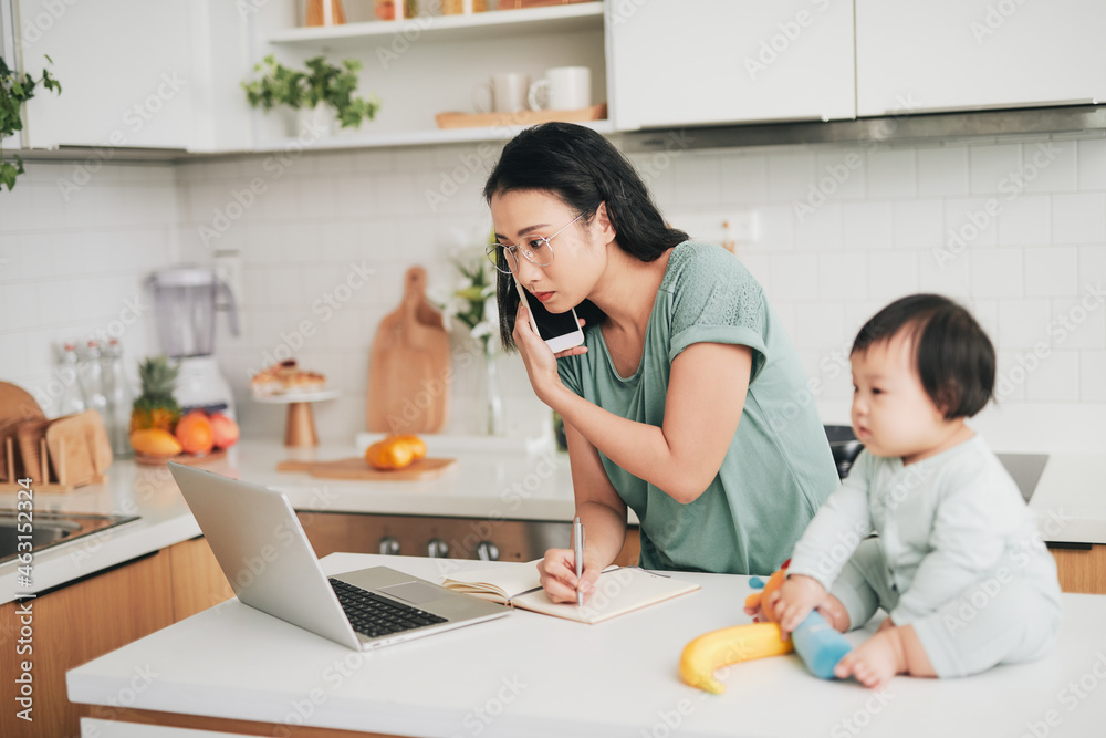 mother with baby, smartphone and laptop working at home mother with baby, smartphone and laptop working at home