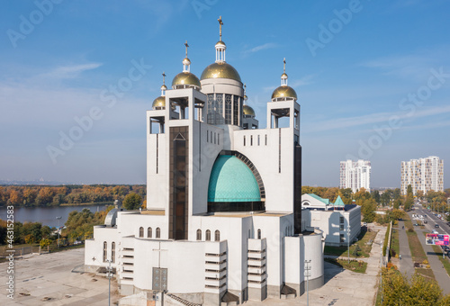 Modern architecture of the temple. White Catholic Church on the banks of the river