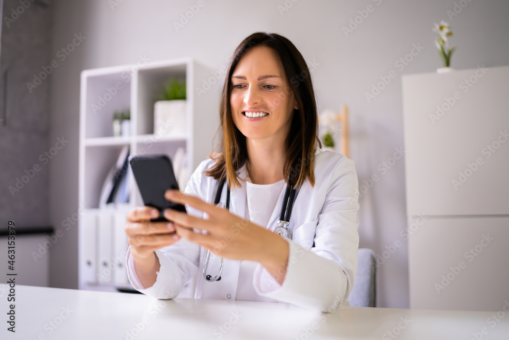 Doctor Having Video Conference On Phone Doctor Having Video Conference On Phone