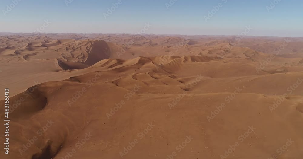 high attitude pan to right aerial shot from the shape of sand dunes in the Lut desert, aerial shot from sand dunes high attitude pan to right aerial shot from the shape of sand dunes in the Lut desert, aerial shot from sand dunes