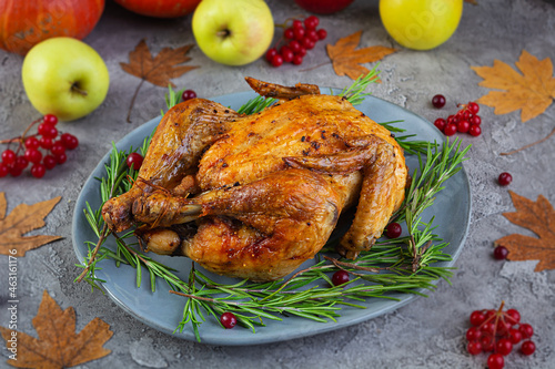 Baked whole chicken or turkey. Roasted homemade chicken with herbs. Thanksgiving day decoration