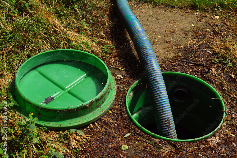 Pumping out sewage from a septic tank. Pipe in the drainage pit. Stock