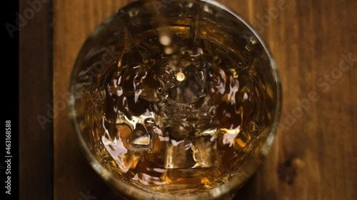 Whiskey is poured into a glass top view slow motion slow motion 1080