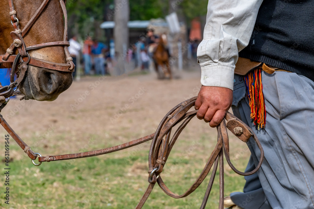 Fototapeta premium Argentine gaucho leading a horse