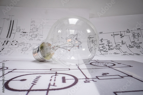 Fotografie, Obraz Closeup of light bulb with cables, fuses, diagrams