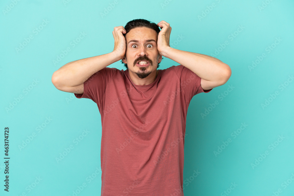 Young caucasian man isolated on blue background doing nervous gesture Young caucasian man isolated on blue background doing nervous gesture