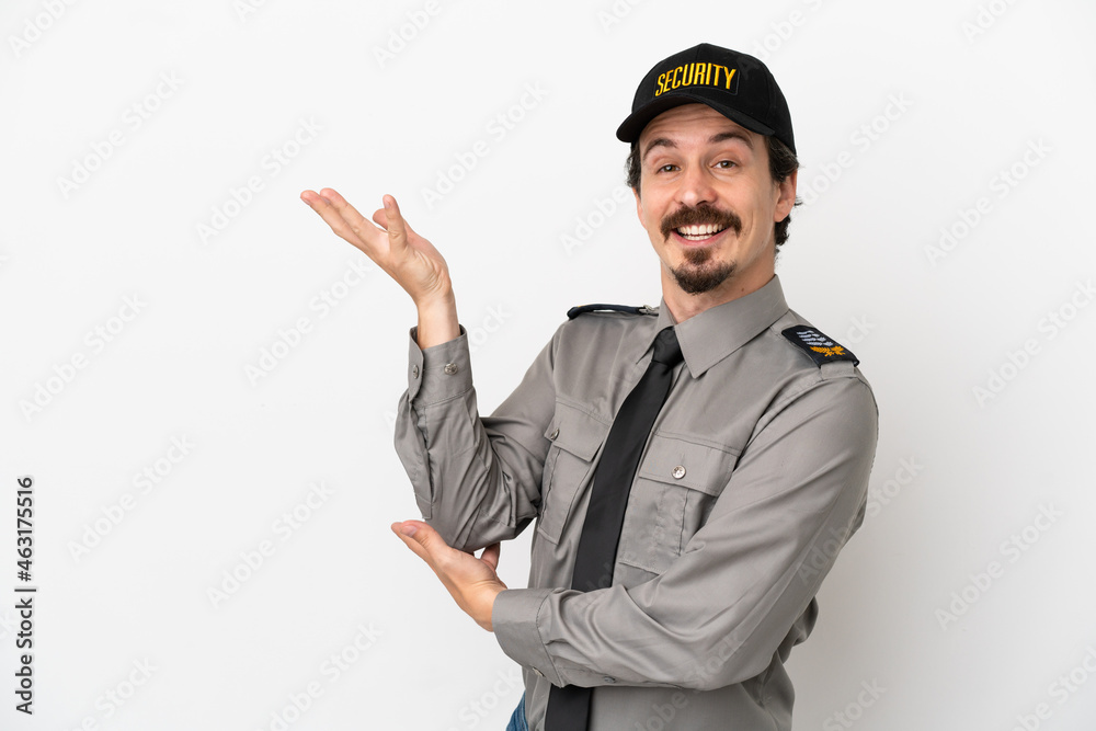 Young caucasian security man isolated on white background extending hands to the side for inviting to come Young caucasian security man isolated on white background extending hands to the side for inviting to come