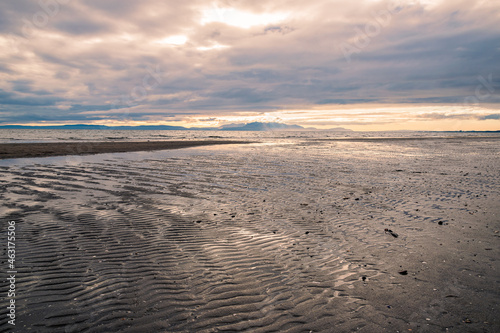 Sandy beach with dramatic clouds at sunset seen from the beach in Irvine  Scotland.