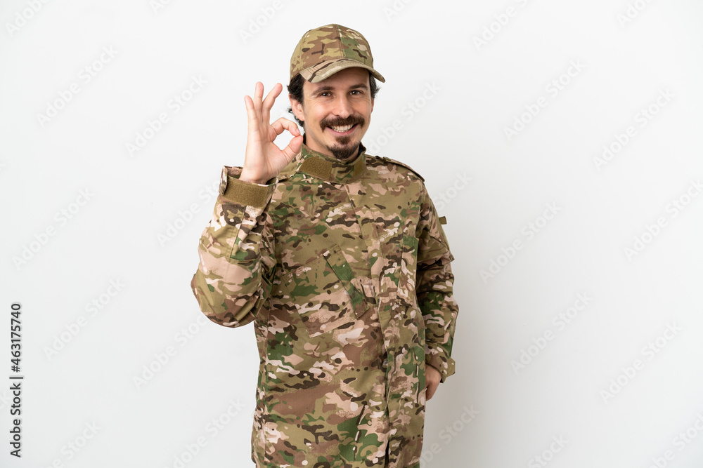 Soldier man isolated on white background showing ok sign with fingers Soldier man isolated on white background showing ok sign with fingers