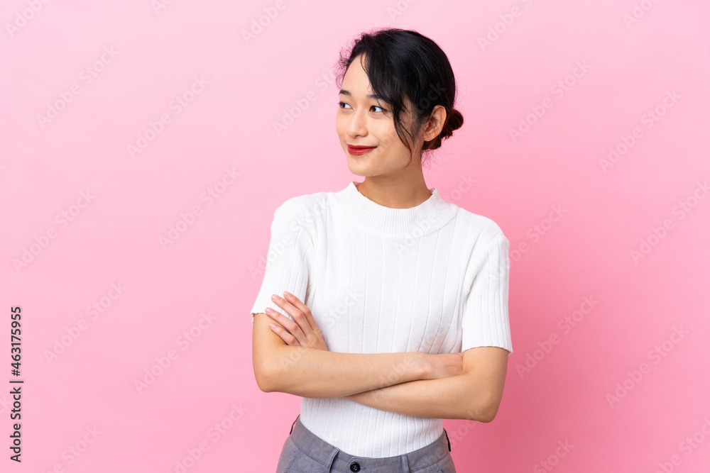 Young Vietnamese woman isolated on pink background looking to the side Young Vietnamese woman isolated on pink background looking to the side