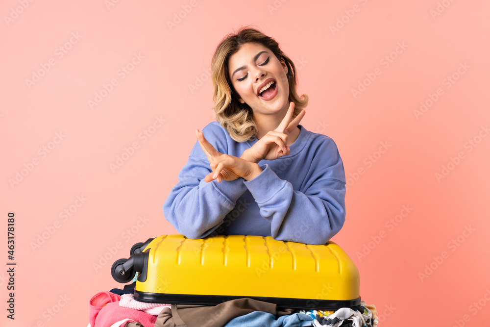 Teenager woman with salad isolated on blue background smiling and showing victory sign Teenager woman with salad isolated on blue background smiling and showing victory sign