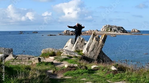 Hiker walking on the beautifful coastline of Brittany in France