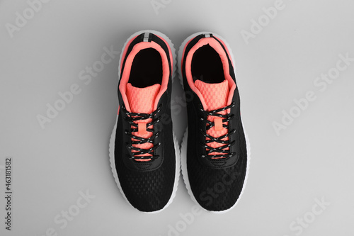 Pair of comfortable sports shoes on grey background, flat lay