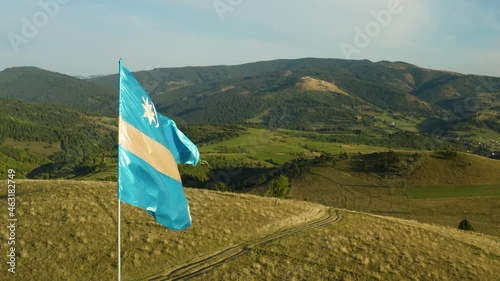 Szekler flag fluttering on the hilltop. photo