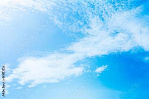 The blue sky is tinged with white clouds in the air on a bright summer day.
