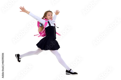 Smiling schoolgirl happily jumping high