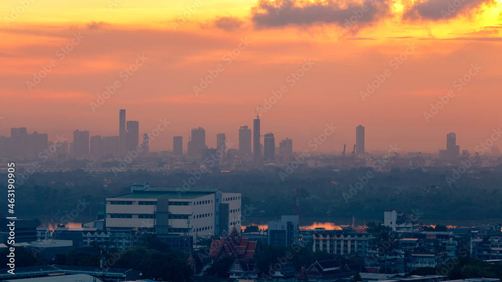 The blurred abstract background of the morning sun exposure to the tiny dust particles that surround the tall buildings in the capital, the long-term health issue of pollution. The blurred abstract background of the morning sun exposure to the tiny dust particles that surround the tall buildings in the capital, the long-term health issue of pollution.