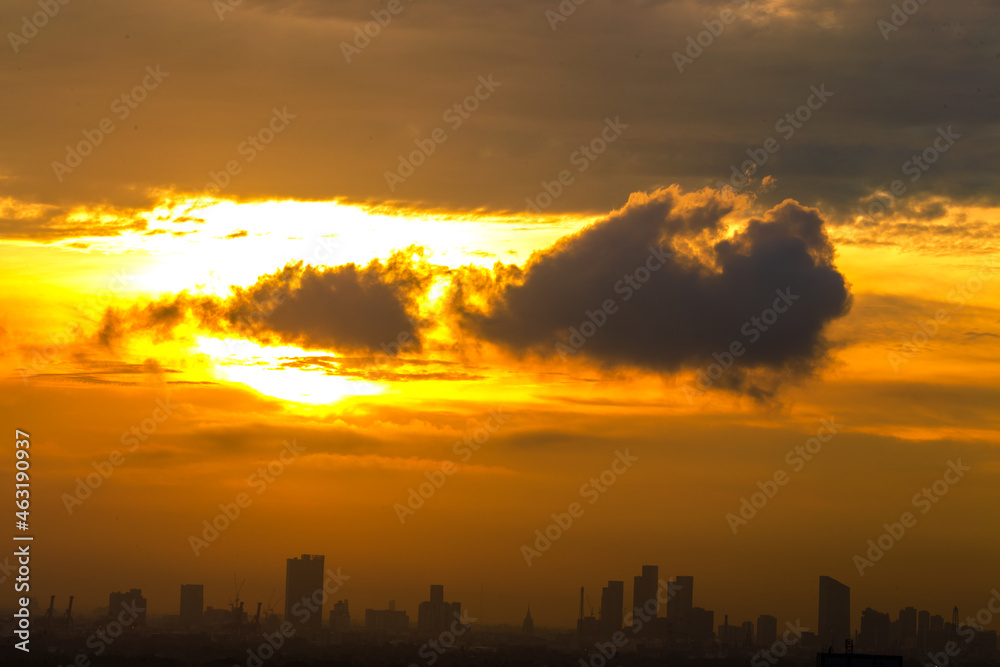 The blurred abstract background of the morning sun exposure to the tiny dust particles that surround the tall buildings in the capital, the long-term health issue of pollution. The blurred abstract background of the morning sun exposure to the tiny dust particles that surround the tall buildings in the capital, the long-term health issue of pollution.