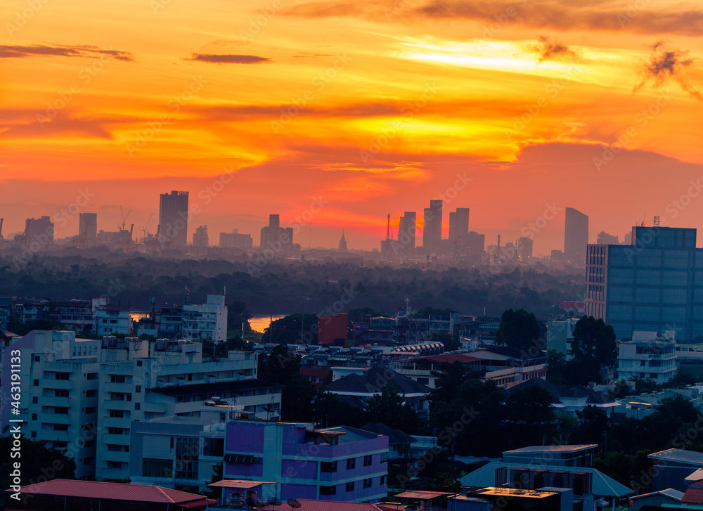 Fototapeta premium The high angle background of the city view with the secret light of the evening, blurring of night lights, showing the distribution of condominiums, dense homes in the capital community