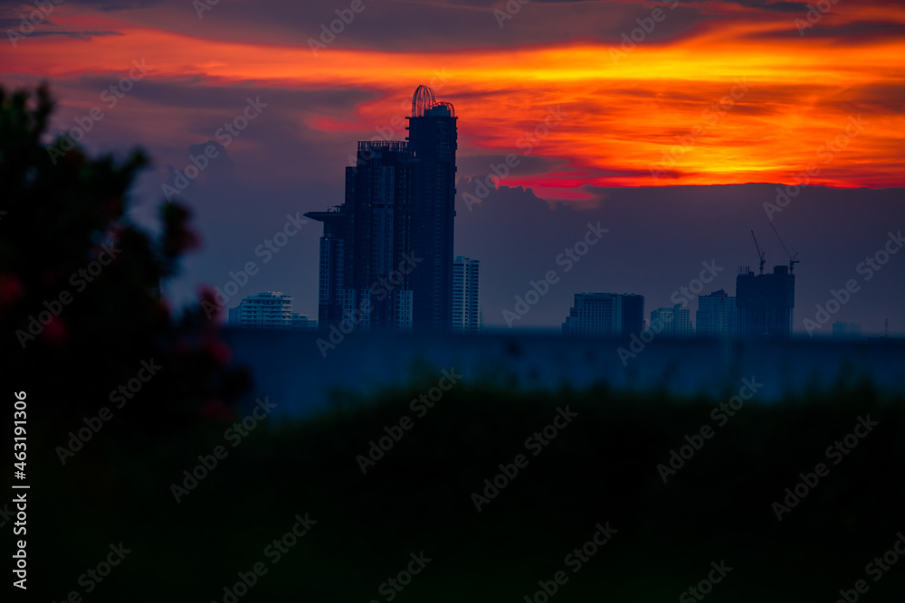 The blurred abstract background of the morning sun exposure to the tiny dust particles that surround the tall buildings in the capital, the long-term health issue of pollution.