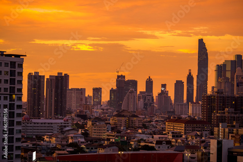 The high angle background of the city view with the secret light of the evening, blurring of night lights, showing the distribution of condominiums, dense homes in the capital community