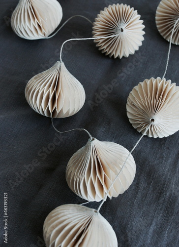 christmas tree decorations garland on gray linen texture background top view....