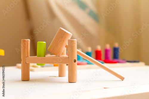Wooden toys for an early age. Educational logic games: hammer, numbers, color sorting. Montessori child development material. . School and kindergarten.