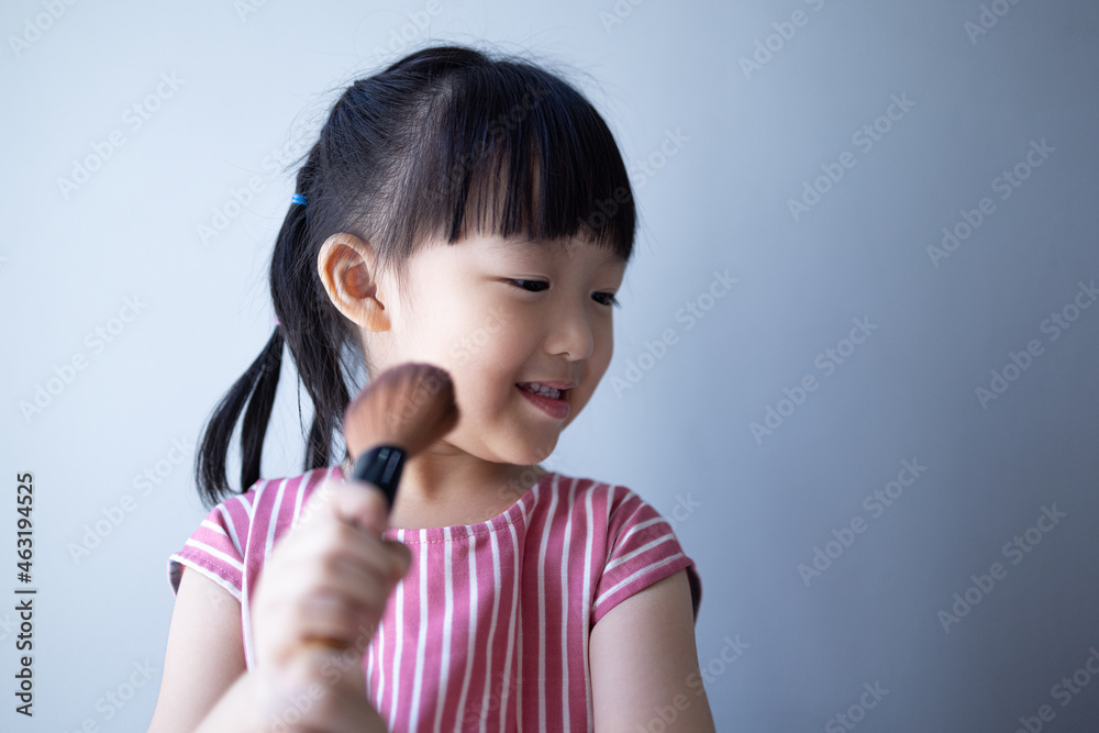 Asian little daughter doing make up herself. Concept of beauty and cosmetic for kid. Asian little daughter doing make up herself. Concept of beauty and cosmetic for kid.