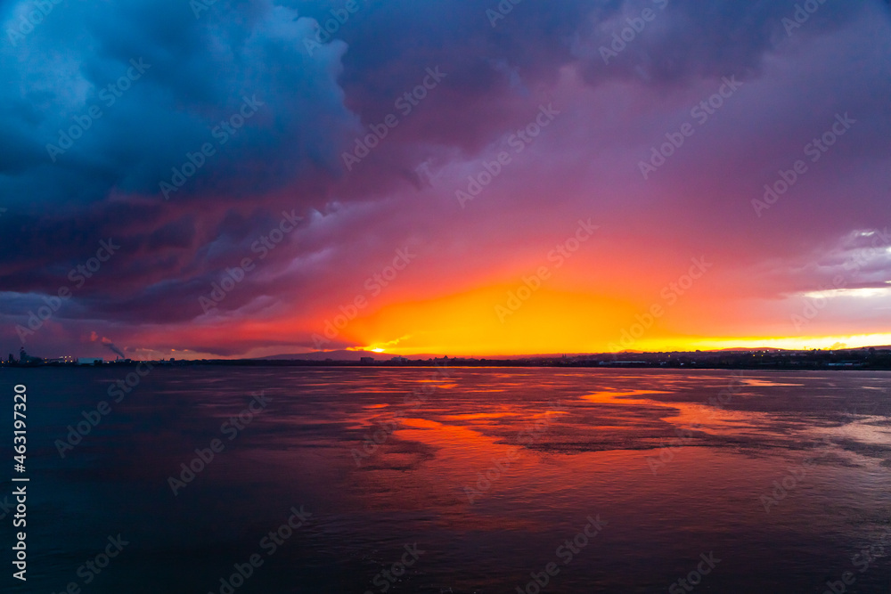 Sunset from the sea bay with red-orange-blue sky.