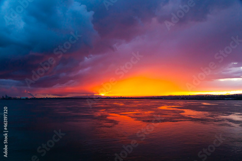 Sunset from the sea bay with red-orange-blue sky.