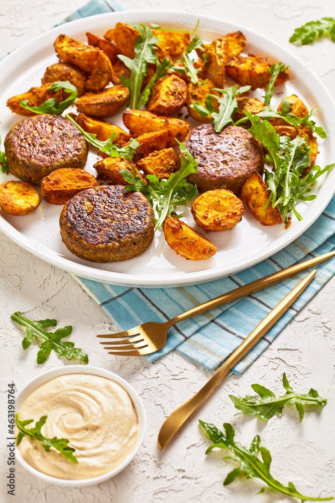 vegan lentil patties with baked potato and hummus