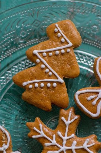 Painted traditional Christmas gingerbreads arranged on old vintage painted table in daylight, common czech tasty sweets