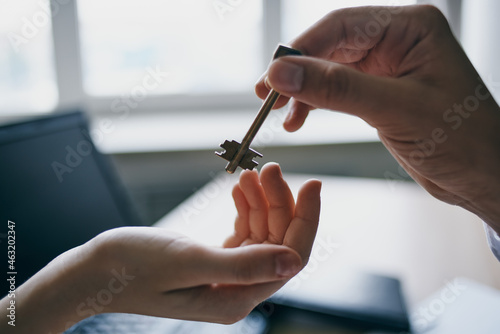 house key in hand for sale real estate agent