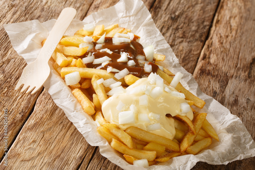 Patatje oorlog or Patat oorlog, Fried oorlog, War Chips, War Fries closeup in the plate on the table. Horizontal