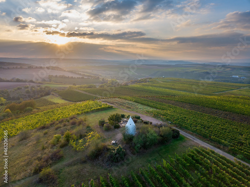 Luftaufnahme Drohnenpanorama eines Flonheimer Trullos und der Weinberge Rheinhessens mit Sonneruntergang im Herbst, Rheinland Pfalz nahe Alzey	 photo