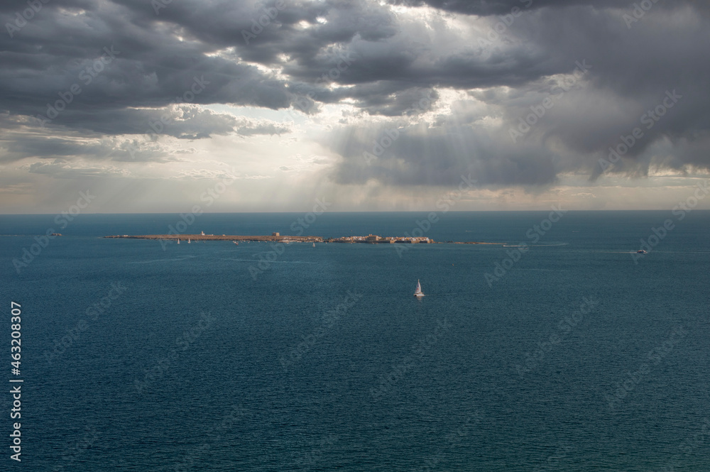 View of the island of Tabarca with storm clouds, from the lighthouse of Santa Pola, ALicante, Spain