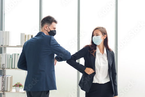 Group of business people in formal suit outfit elbow greeting to work colleague with new normal style in modern workplace office. photo