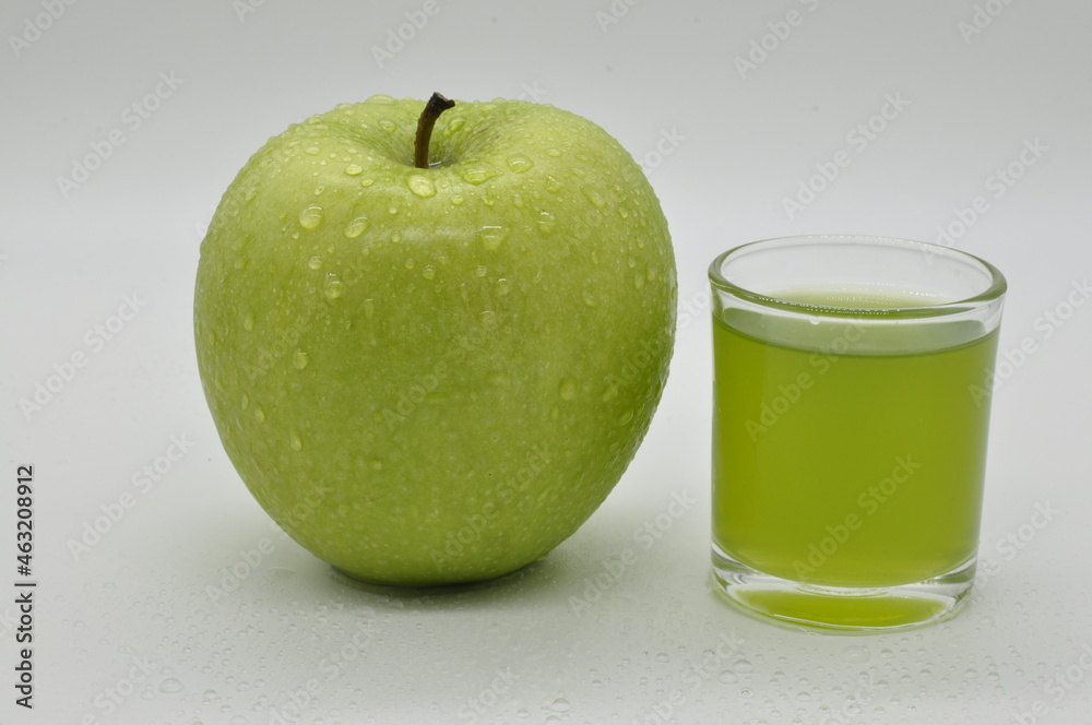Apples and apple juice against a white background. Apples and apple juice against a white background.