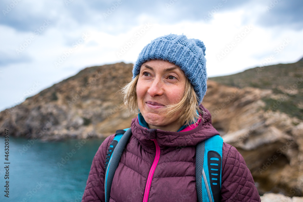 Portrait of a smiling girl in a knitted hat while walking along the sea coast Portrait of a smiling girl in a knitted hat while walking along the sea coast