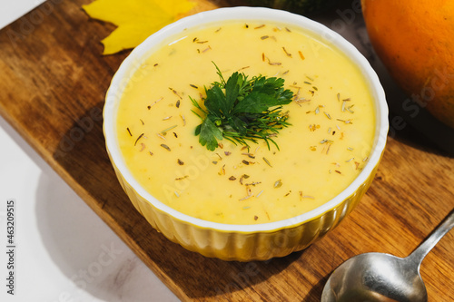 Pumpkin pureed soup. Bowl of vegetable cream soup with pumpkin and herbs.