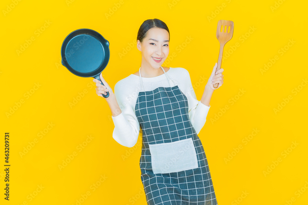 Portrait beautiful young asian woman with pan and big spoon Portrait beautiful young asian woman with pan and big spoon