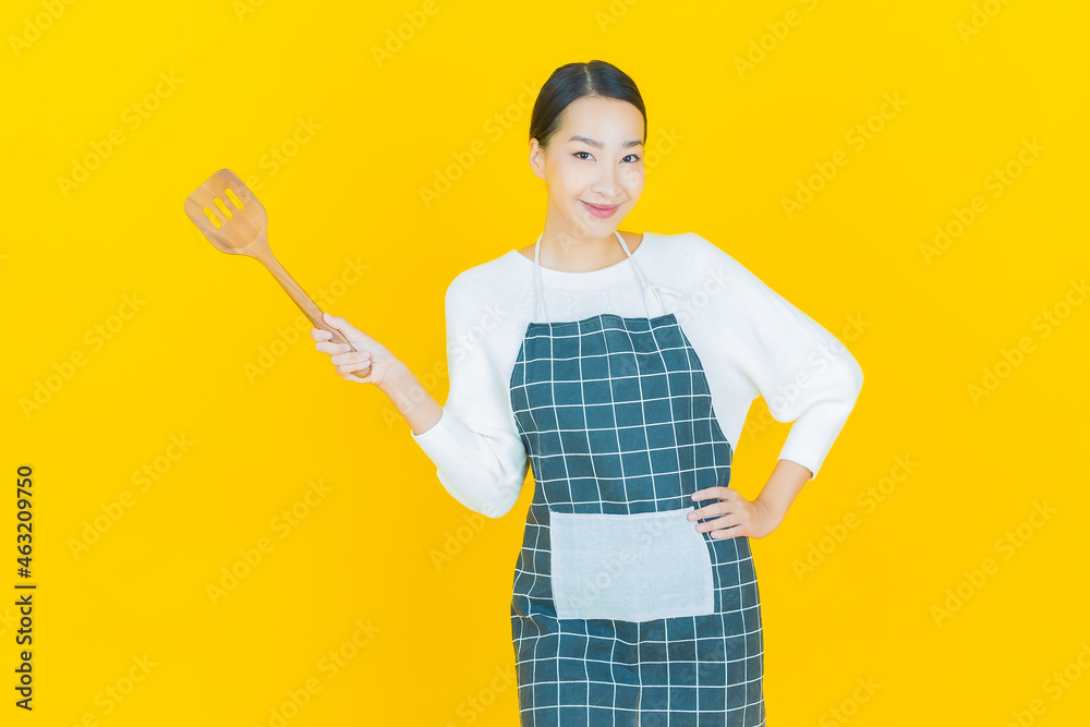 Portrait beautiful young asian woman with pan and big spoon Portrait beautiful young asian woman with pan and big spoon