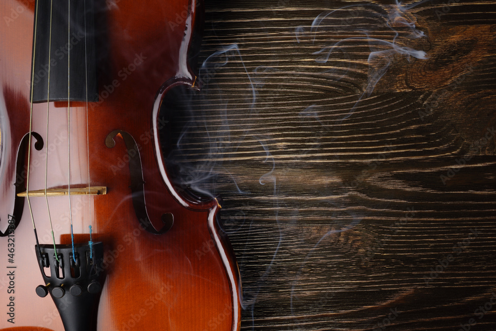 Fototapeta premium Violin on brown wooden table.
