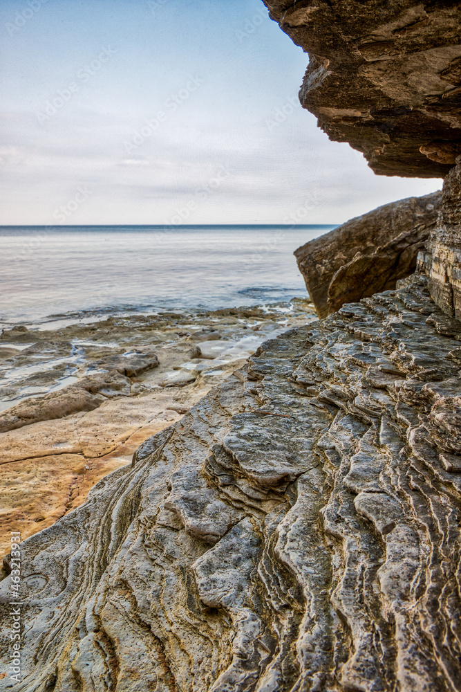 Wet stone wall at sunrise by the sea Wet stone wall at sunrise by the sea