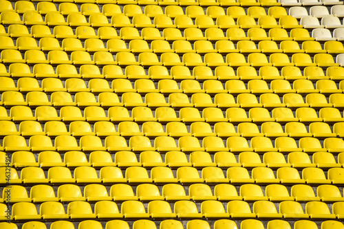 Bilde på lerret lots of rows with yellow seats for people on the football field in the summer