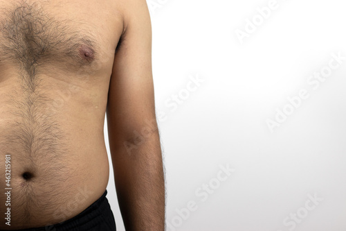 A front-side photo of a shirtless man with a rather fat, bulging body and hair on the chest, abdomen, on a white background with space for text.
