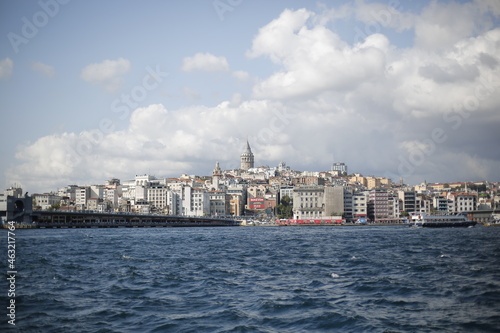 A tour on the coast of the Bosphorus in Istanbul - Turkey Boats and tourists on the Galata Bridge and Galata Tower and fishermen. Seagulls are flying, an old man and his wife are back watching the sun © Anas