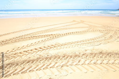 Traces of tractor wheels on the beach