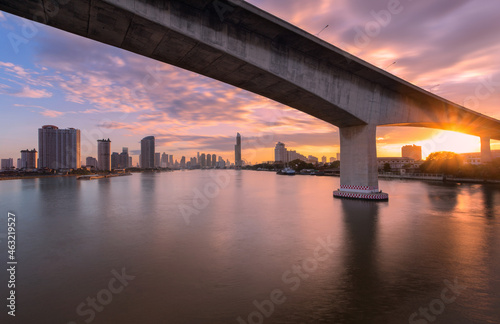 Aerial view night time lapse of landmark financial district and business center with skyscraper over Chao Phraya River at Bangkok, Thailand.